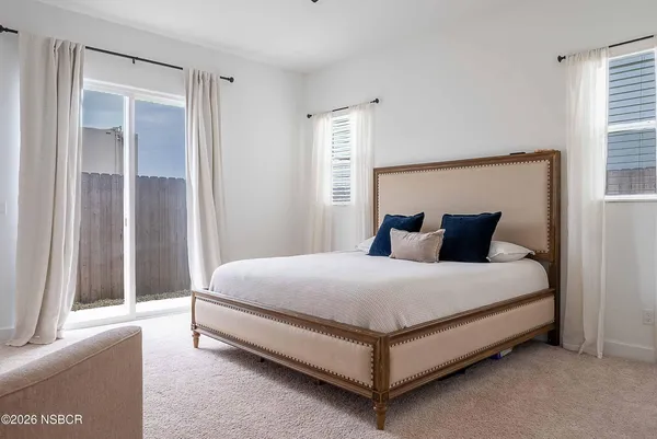 a bedroom with a bed and a couch