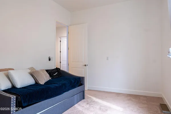 a bathroom with a sink a toilet a mirror and shower curtain