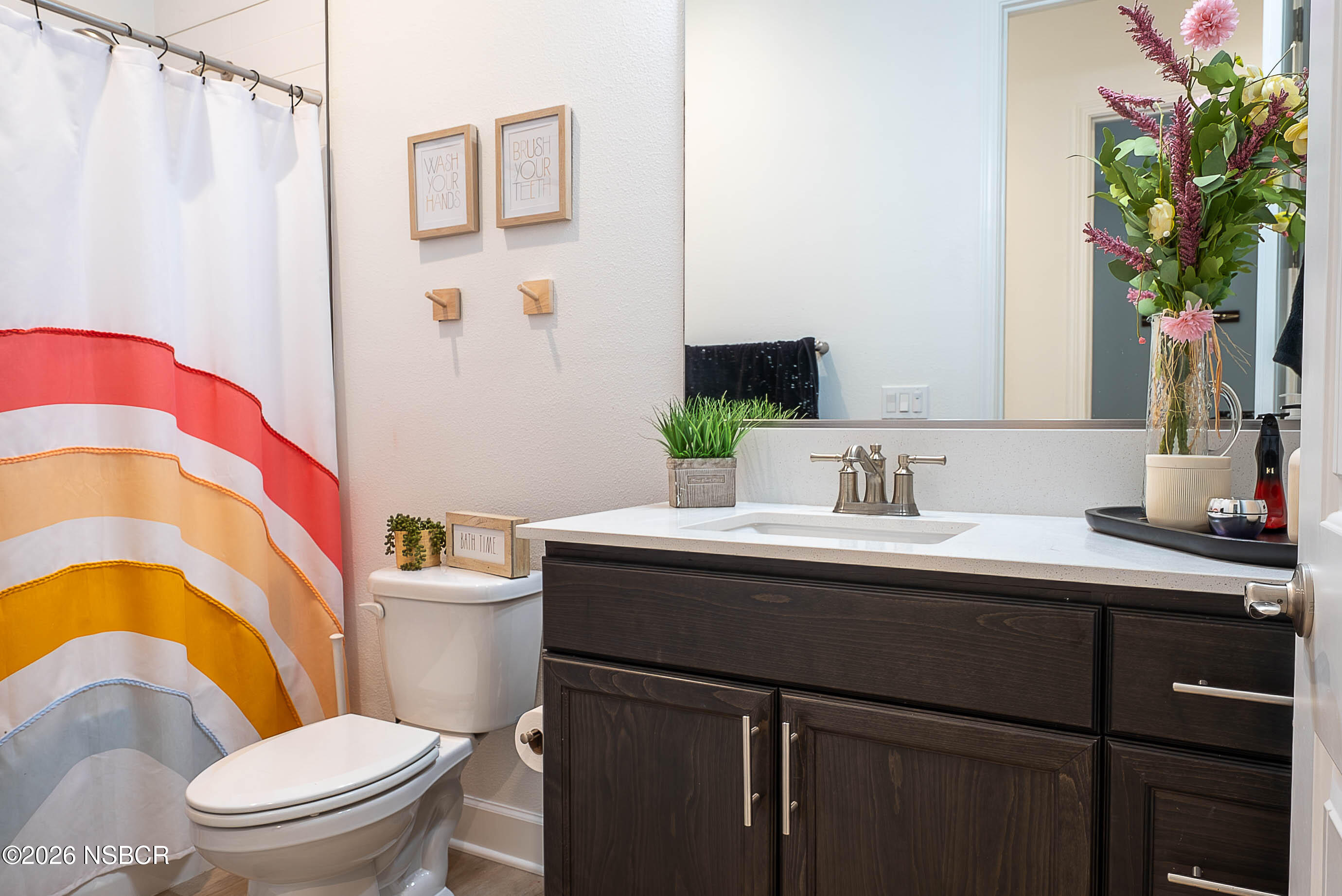 751 Skyview Lane Santa Maria, CA 93455 - Photo 21 of 27 a bathroom with a sink a toilet a mirror and shower curtain