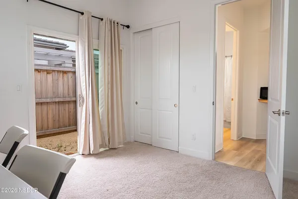 a bathroom with a sink a toilet a window and shower