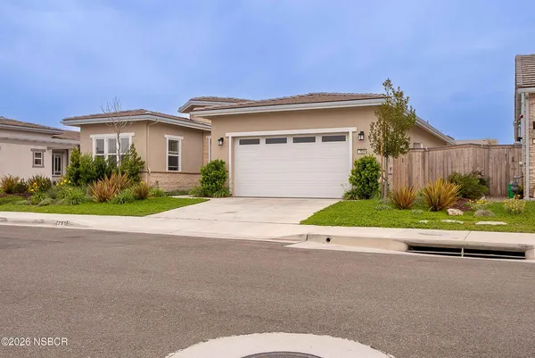 a front view of a house with a yard and a garage