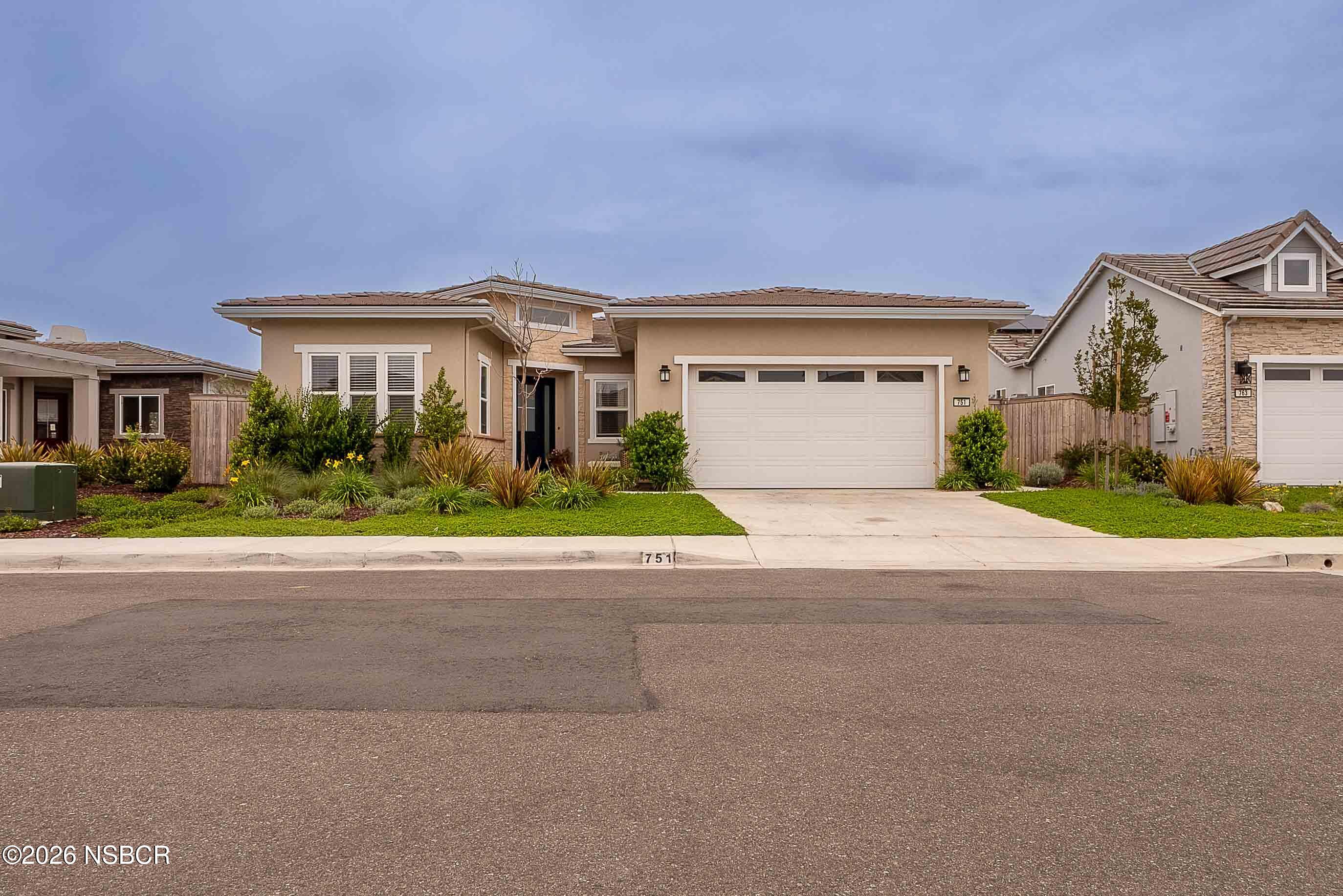 751 Skyview Lane Santa Maria, CA 93455 - Photo 27 of 27 a front view of a house with a yard and a garage