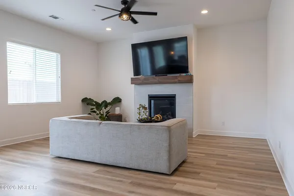 a living room with fireplace furniture and a flat screen tv
