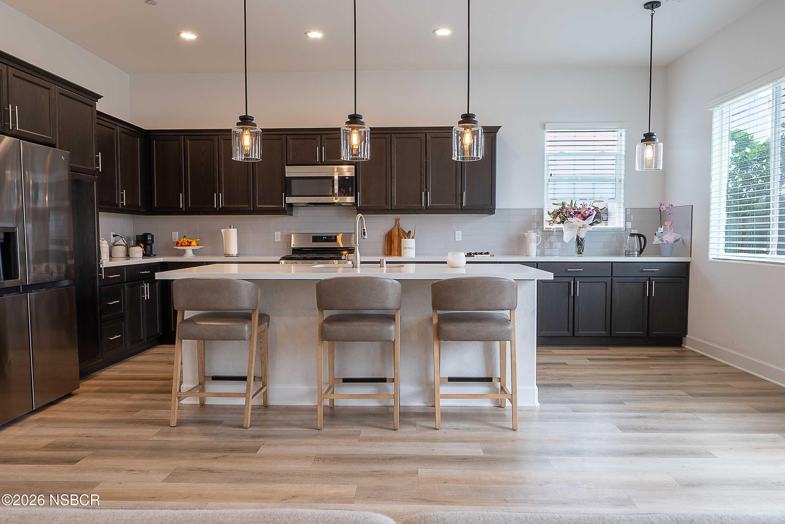 751 Skyview Lane Santa Maria, CA 93455 - Photo 9 of 27 a kitchen with a sink and chairs