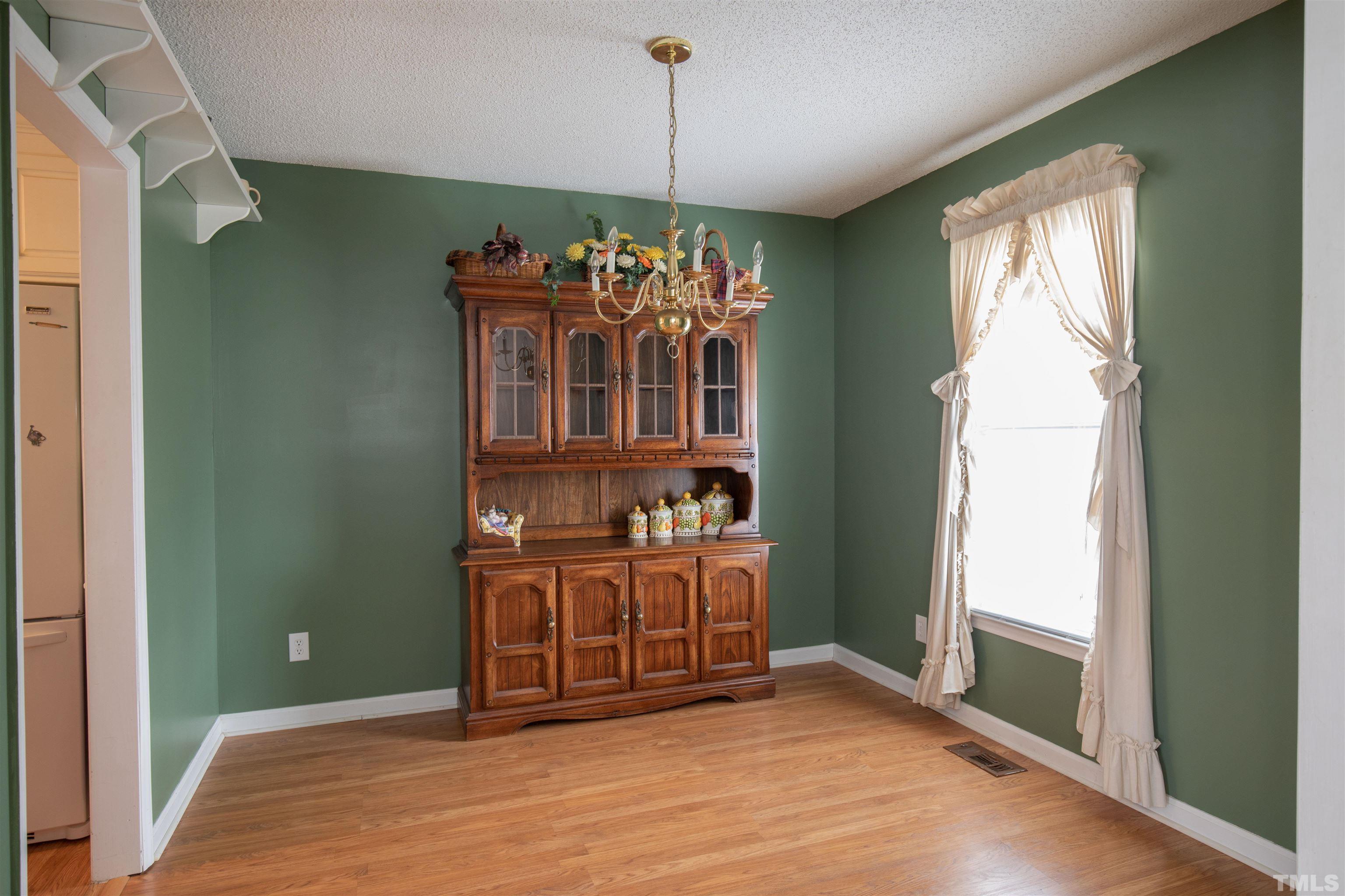300 Sanders Road Benson, NC 27504 - Photo 3 of 24 a view of a hallway with windows and chandelier