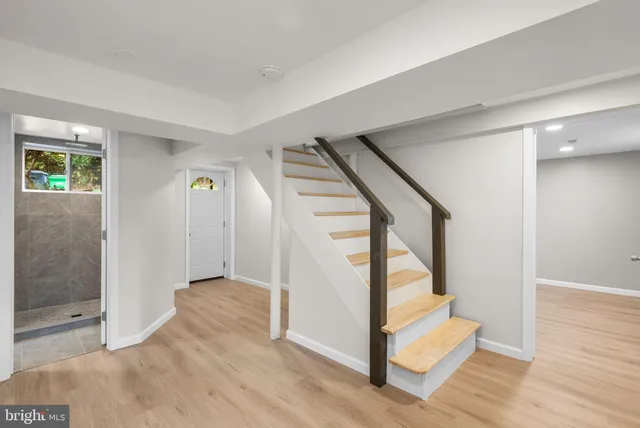 a view of entryway with wooden floor and stairs