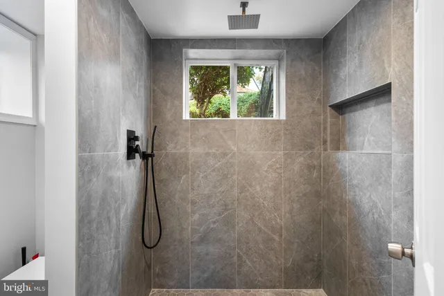 a bathroom with a window and a shower