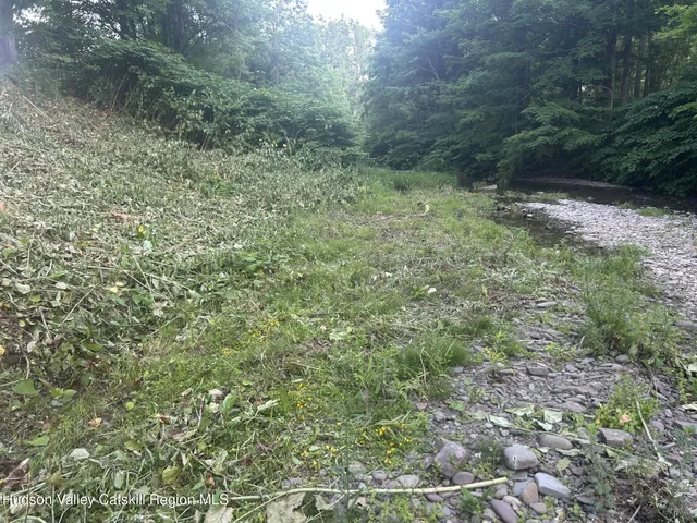 an aerial view of a house with garden space table and chairs in the patio