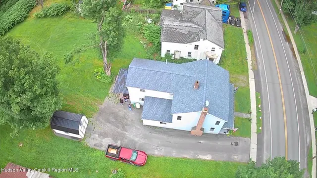 an aerial view of a house with outdoor space and street view
