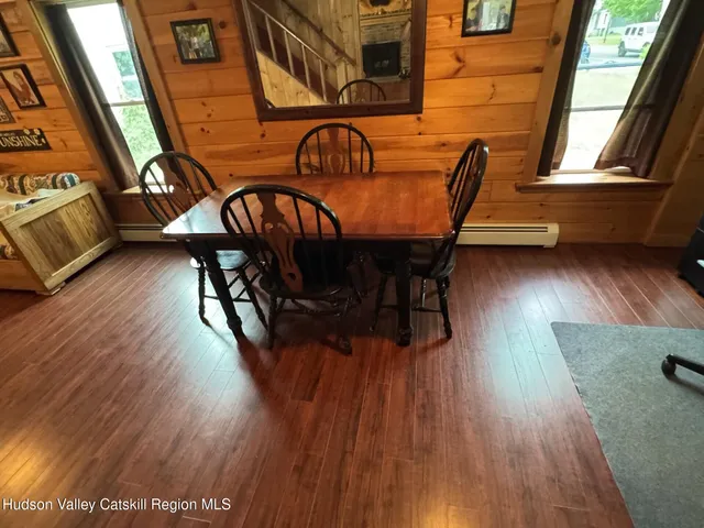 a view of a dining room with furniture window and wooden floor