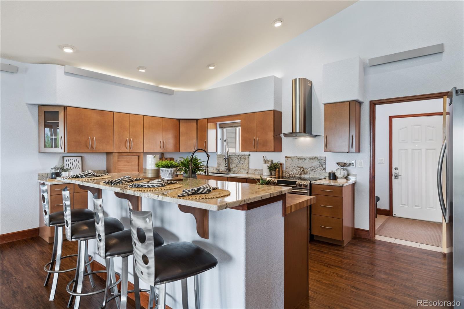 17622 County Road 1 Berthoud, CO 80513 - Photo 11 of 37 a kitchen with stainless steel appliances a stove a sink a refrigerator and chairs