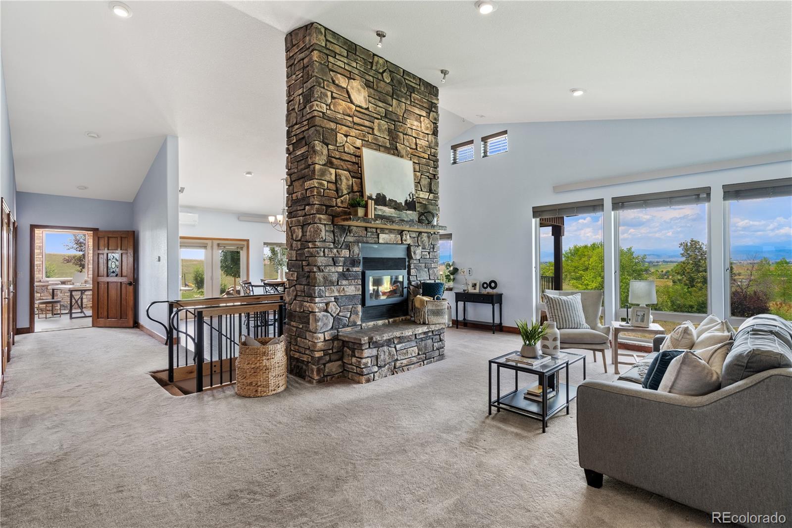 17622 County Road 1 Berthoud, CO 80513 - Photo 15 of 37 a living room with fireplace furniture and a large window