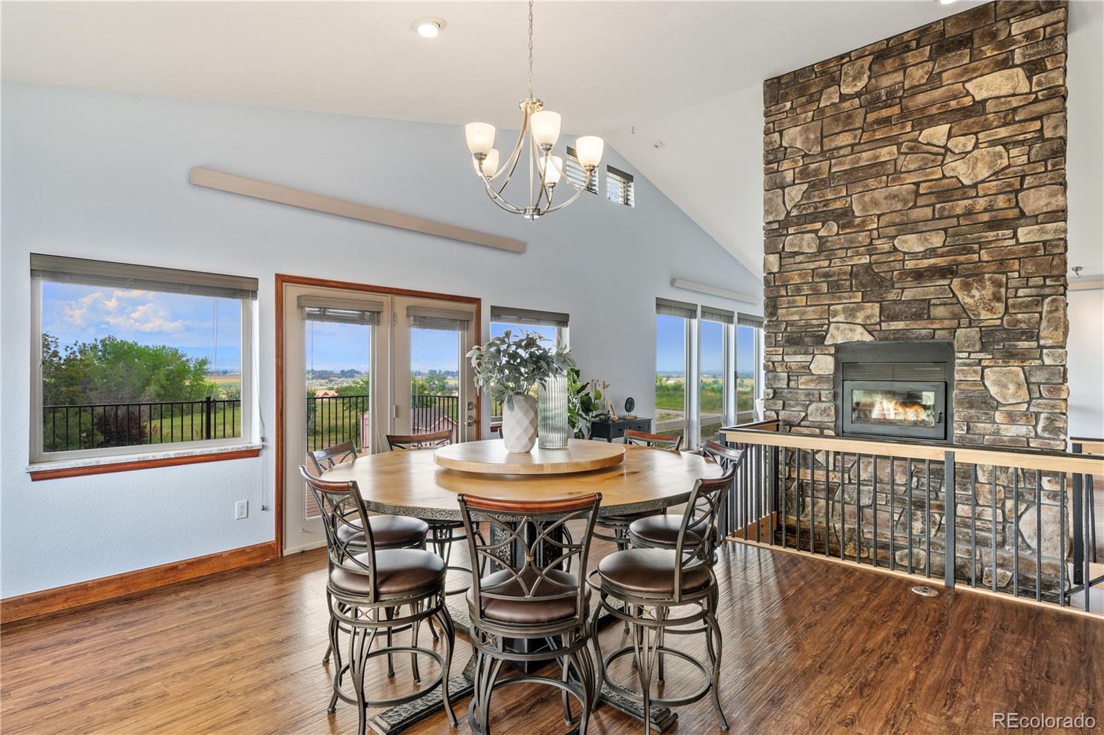 17622 County Road 1 Berthoud, CO 80513 - Photo 18 of 37 a dining room with furniture a large window and wooden floor