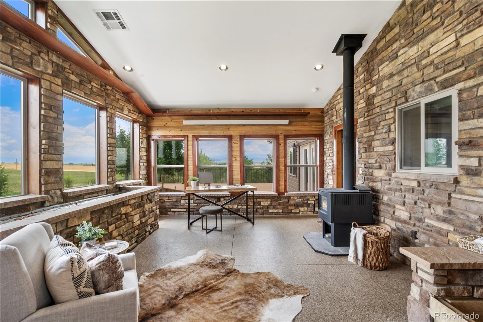 17622 County Road 1 Berthoud, CO 80513 - Photo 19 of 37 a living room with furniture and floor to ceiling windows