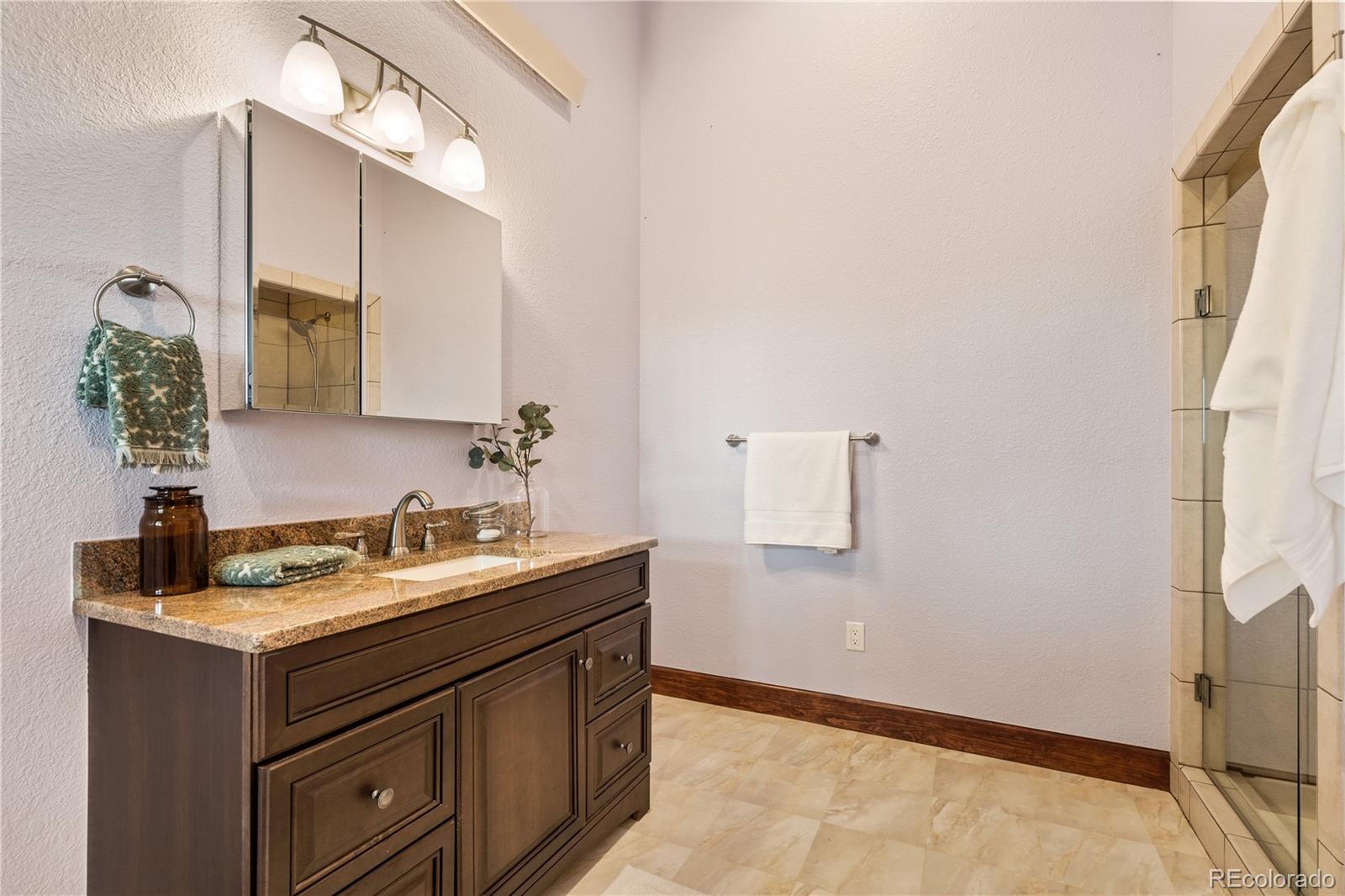 17622 County Road 1 Berthoud, CO 80513 - Photo 22 of 37 a bathroom with a sink and a mirror