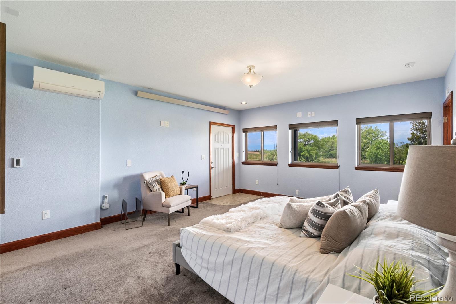 17622 County Road 1 Berthoud, CO 80513 - Photo 24 of 37 a bedroom with a bed and glass window