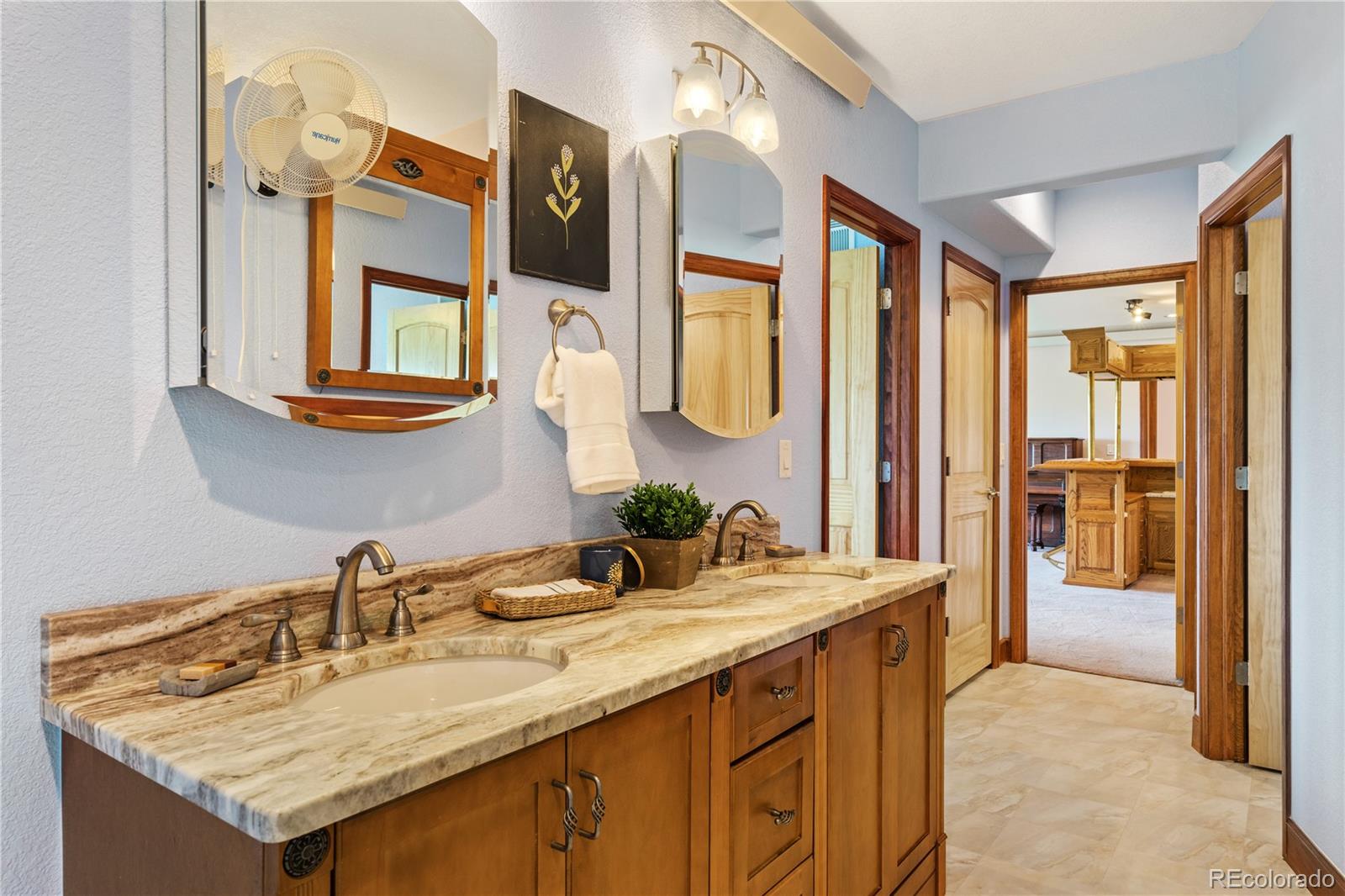 17622 County Road 1 Berthoud, CO 80513 - Photo 27 of 37 a bathroom with a granite countertop sink and a mirror