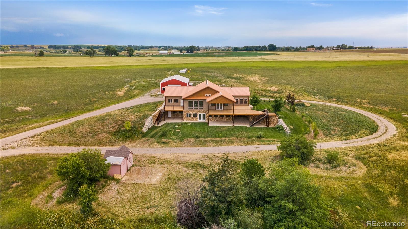 17622 County Road 1 Berthoud, CO 80513 - Photo 3 of 37 a view of a lake with a table and chairs