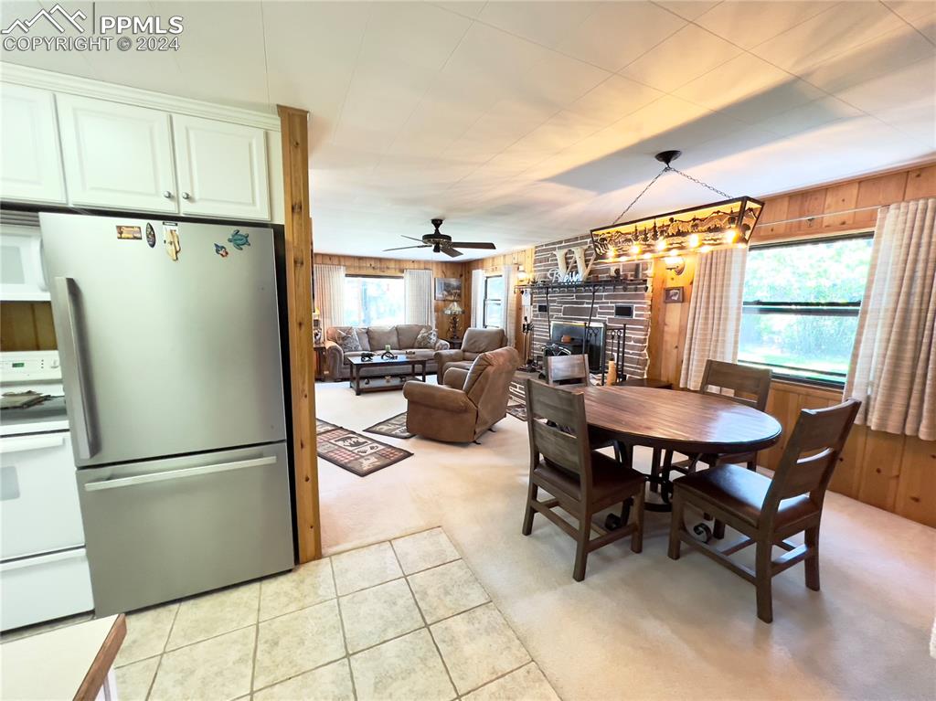 8149 Patti Drive Rye, CO 81069 - Photo 12 of 27 a kitchen with stainless steel appliances a dining table chairs refrigerator and sink