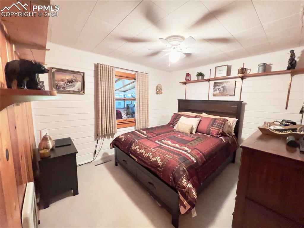 8149 Patti Drive Rye, CO 81069 - Photo 14 of 27 a bedroom with a bed and wooden floor