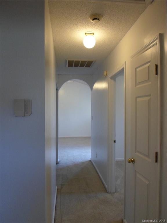 4310 Frank Vance Road Charlotte, NC 28216 - Photo 19 of 24 a view of a hallway with wooden floor