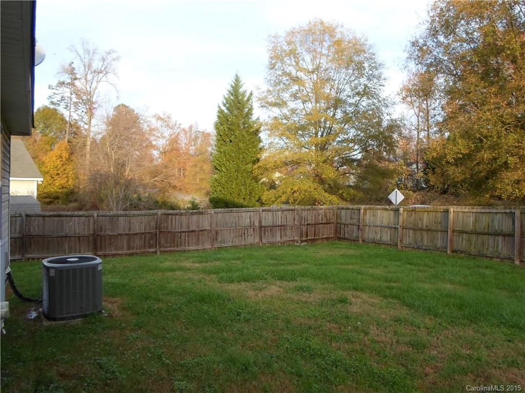 4310 Frank Vance Road Charlotte, NC 28216 - Photo 20 of 24 a view of a backyard with a swing and wooden fence