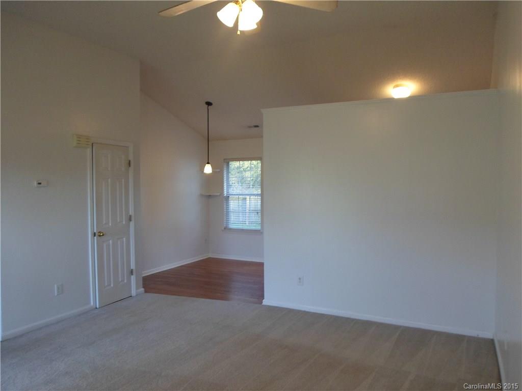 4310 Frank Vance Road Charlotte, NC 28216 - Photo 4 of 24 an empty room with windows and fan