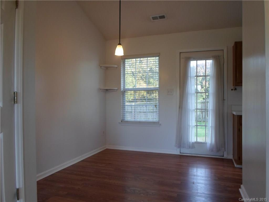 4310 Frank Vance Road Charlotte, NC 28216 - Photo 7 of 24 a view of an empty room with wooden floor and a window