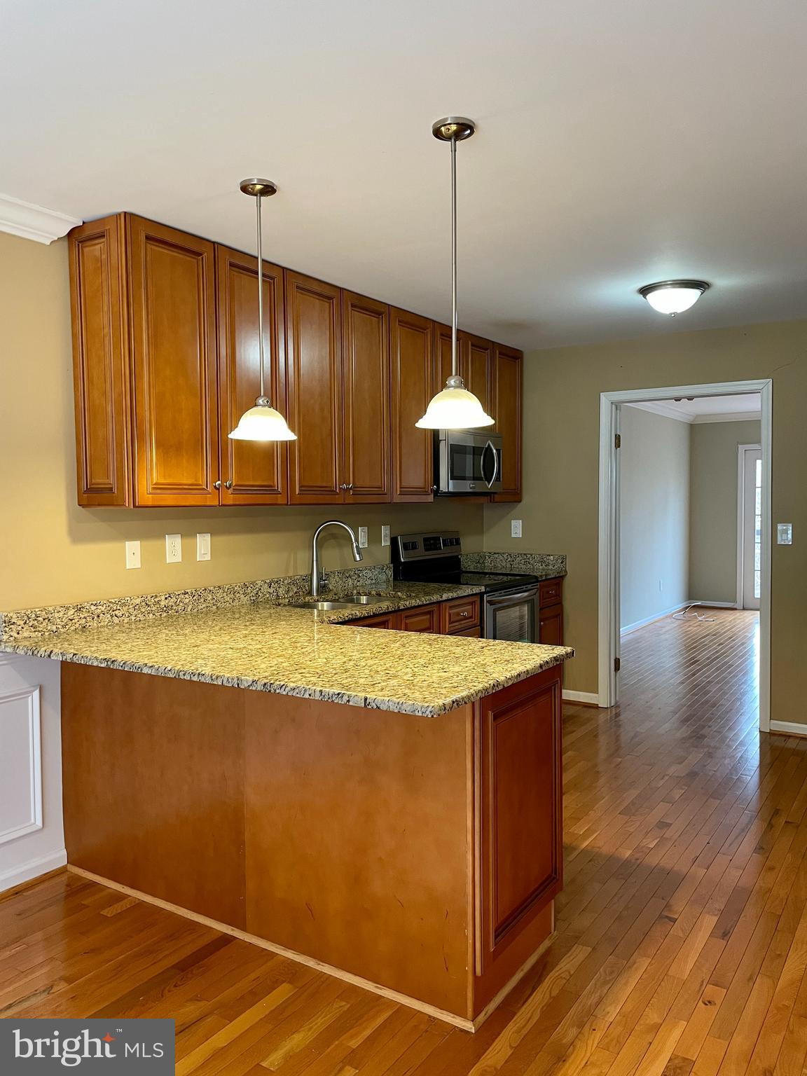 503 Brighton Road, Unit 5C Devon, PA 19333 - Photo 5 of 20 a kitchen with stainless steel appliances granite countertop a sink a counter space and cabinets