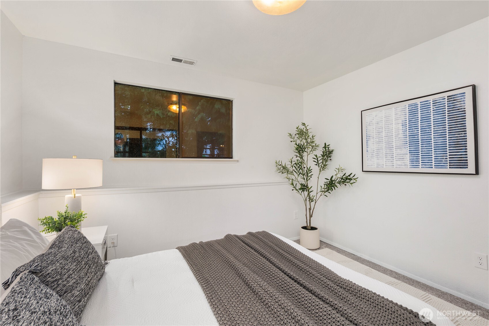 25330 215th Place Southeast Maple Valley, WA 98038 - Photo 20 of 40 a bedroom with a bed and a potted plant