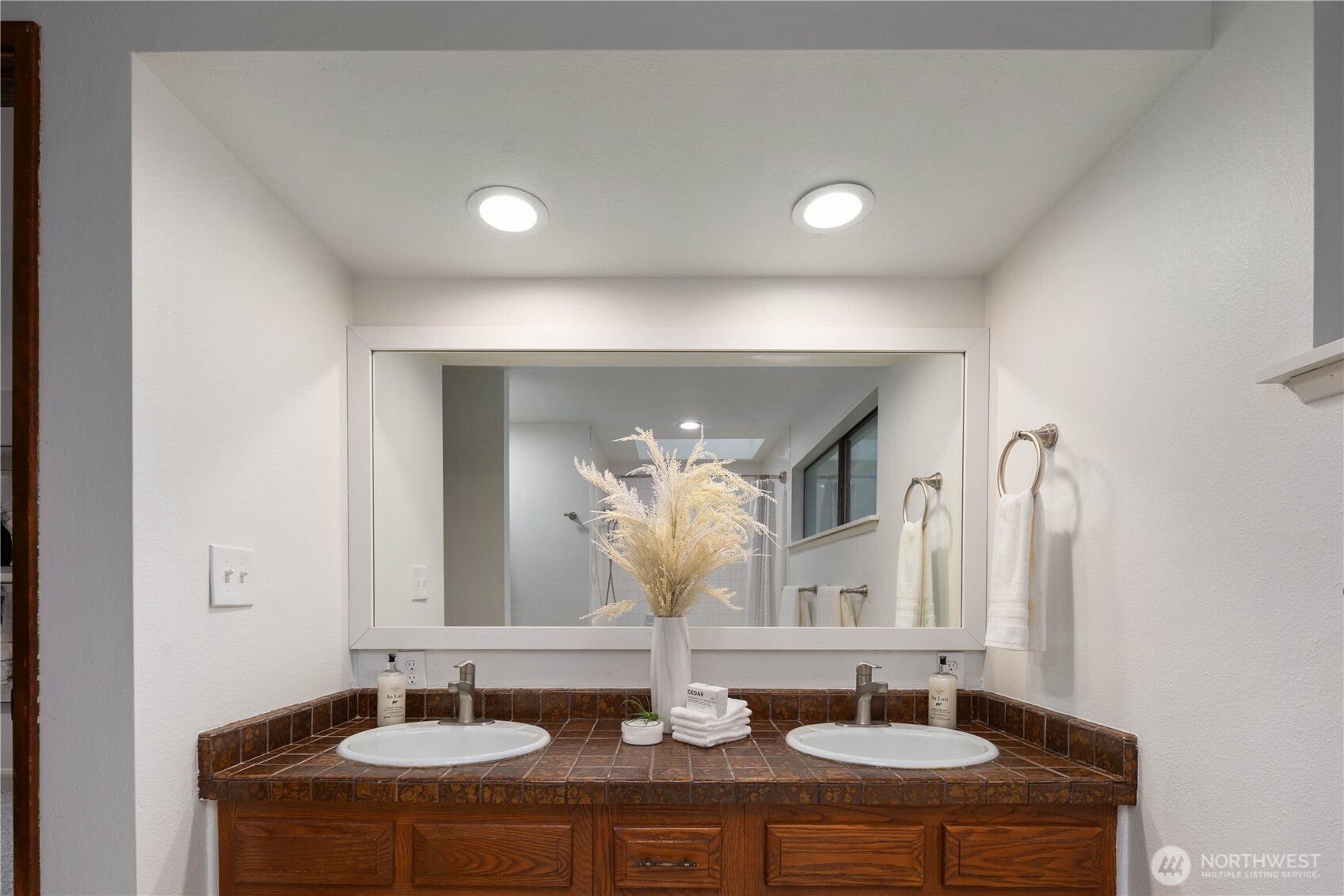 25330 215th Place Southeast Maple Valley, WA 98038 - Photo 26 of 40 a bathroom with double vanity sinks and a mirror