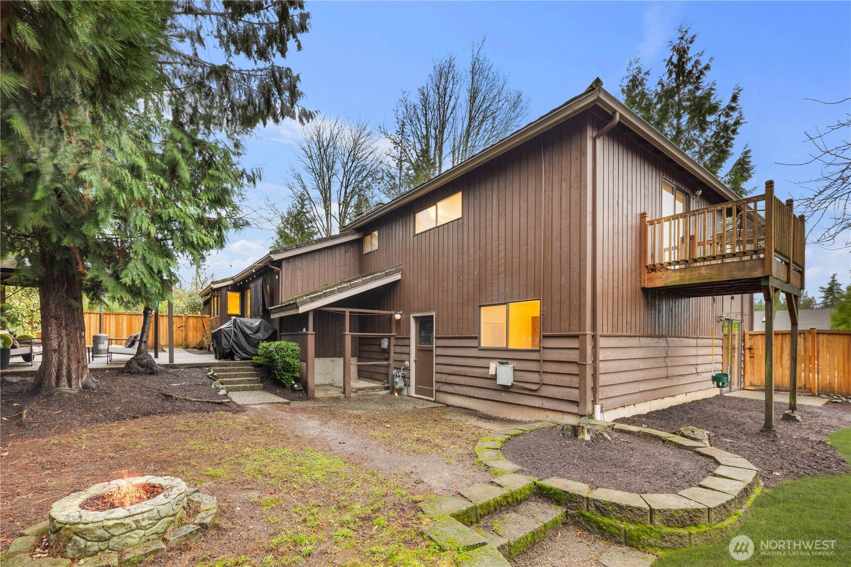 25330 215th Place Southeast Maple Valley, WA 98038 - Photo 32 of 40 a yellow house with trees in front of it