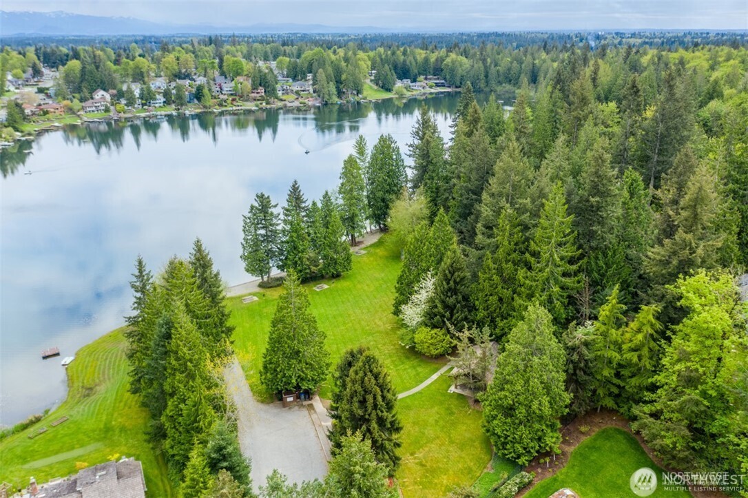 25330 215th Place Southeast Maple Valley, WA 98038 - Photo 40 of 40 a view of a lake with a house in the background