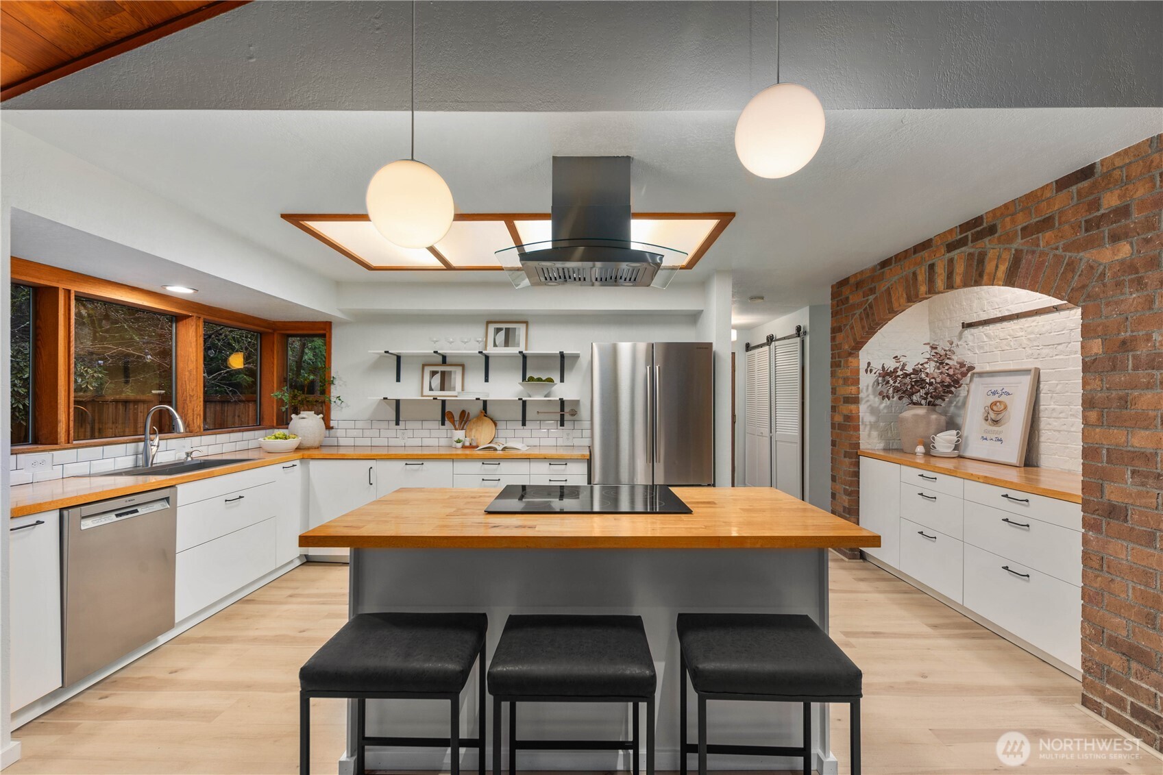 25330 215th Place Southeast Maple Valley, WA 98038 - Photo 10 of 40 a dining room with wooden floor a chandelier a wooden table and chairs