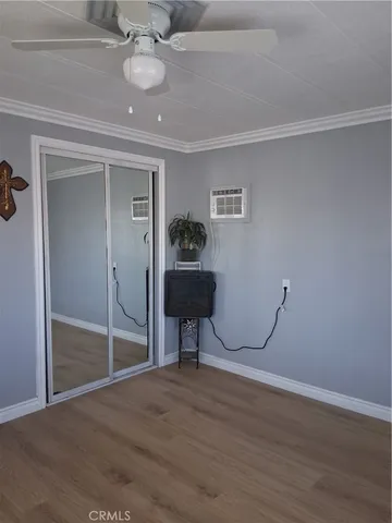 a view of a room with wooden floor table and closet