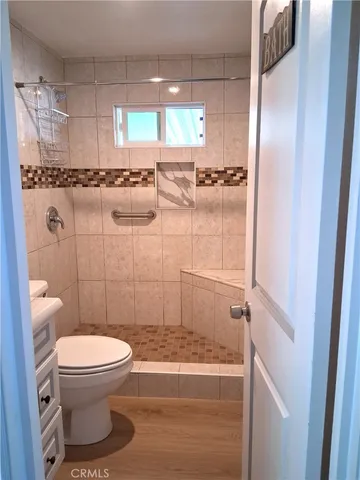 a bathroom with a toilet and a shower