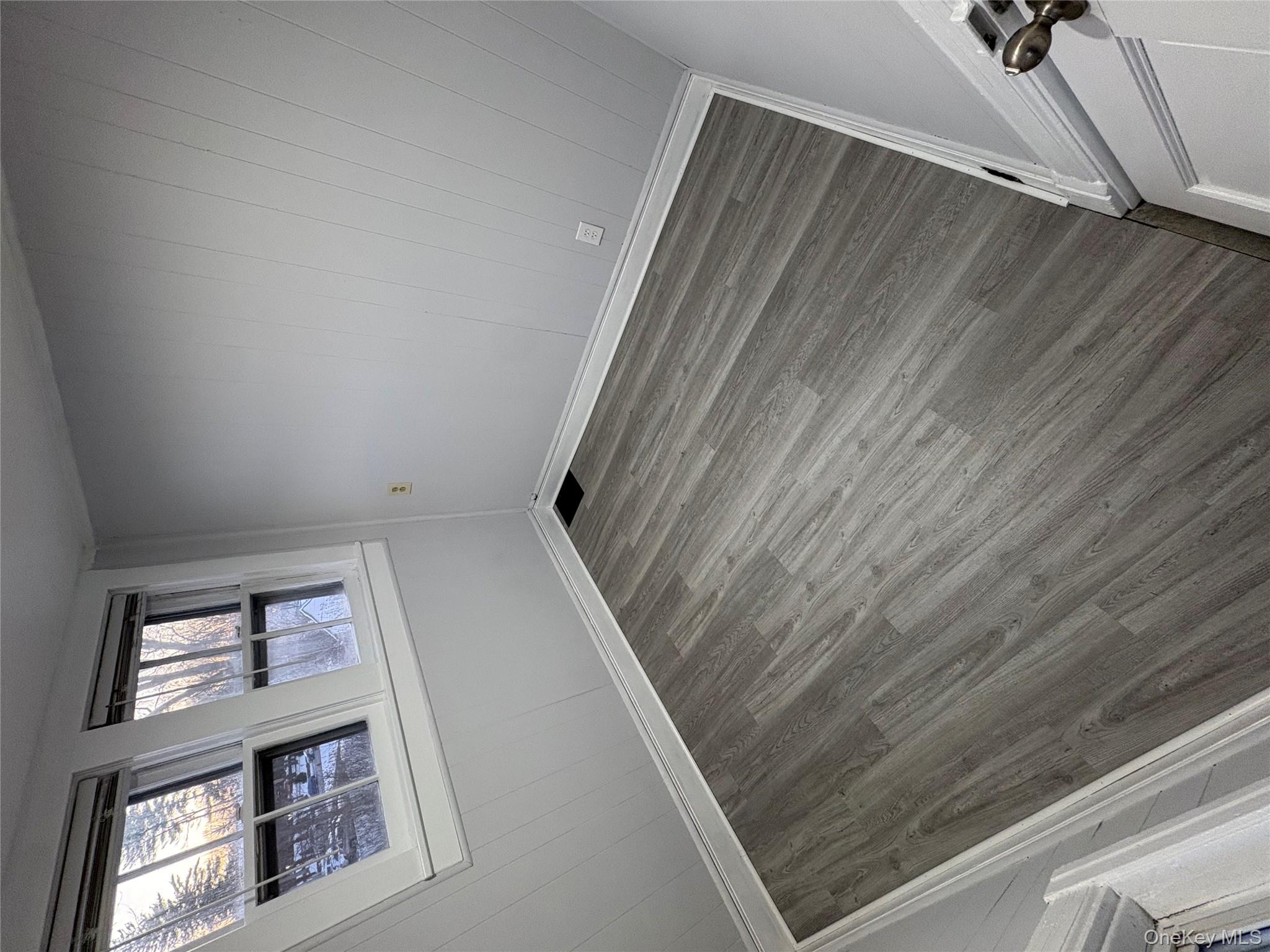 24 Lagrange Avenue Poughkeepsie, NY 12603 - Photo 3 of 10 Empty room with wooden walls and wood finished floors