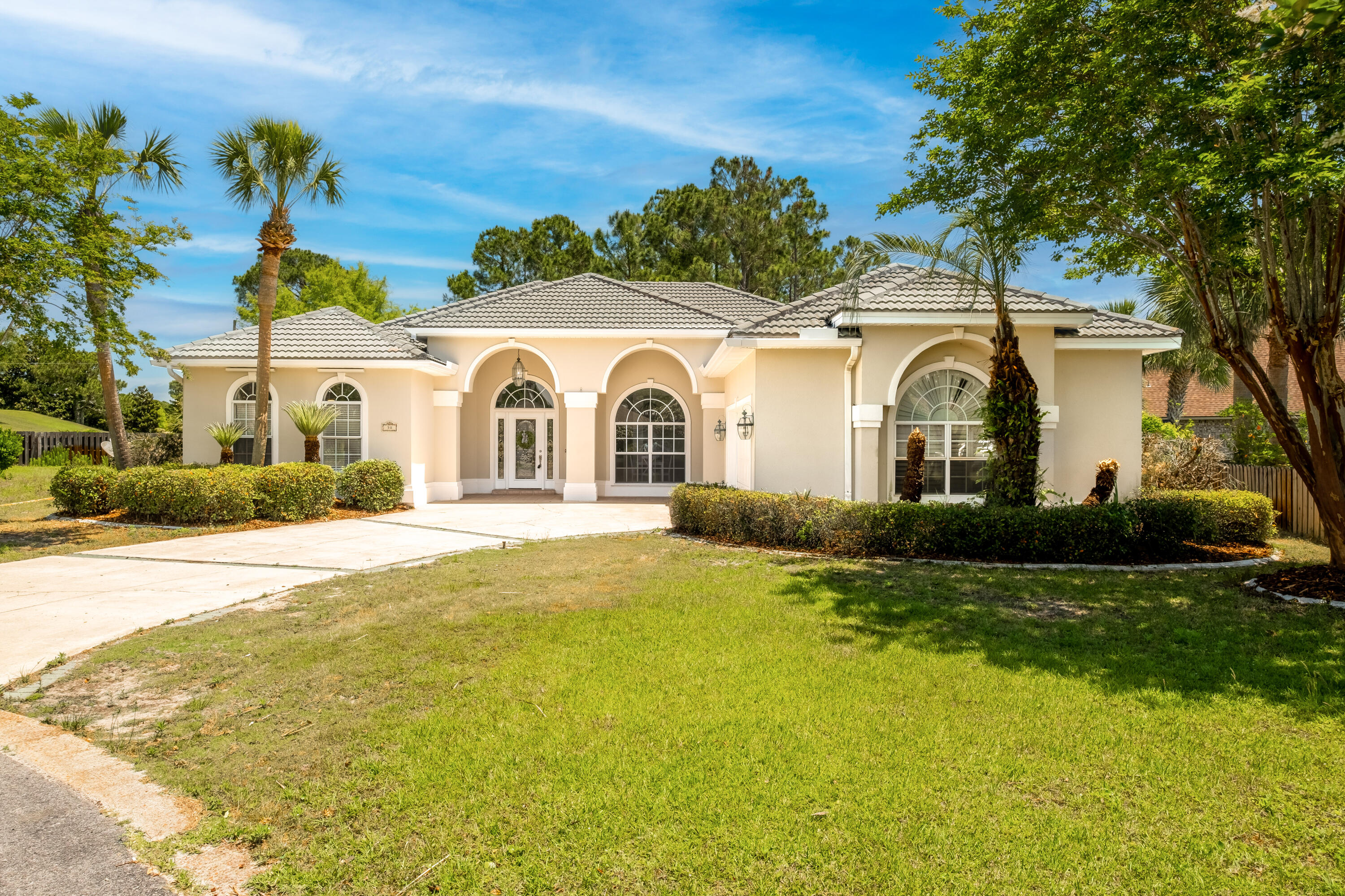 38 Kristin Cove Destin, FL 32541 - Photo 1 of 57 a view of a white house with a big yard and large trees