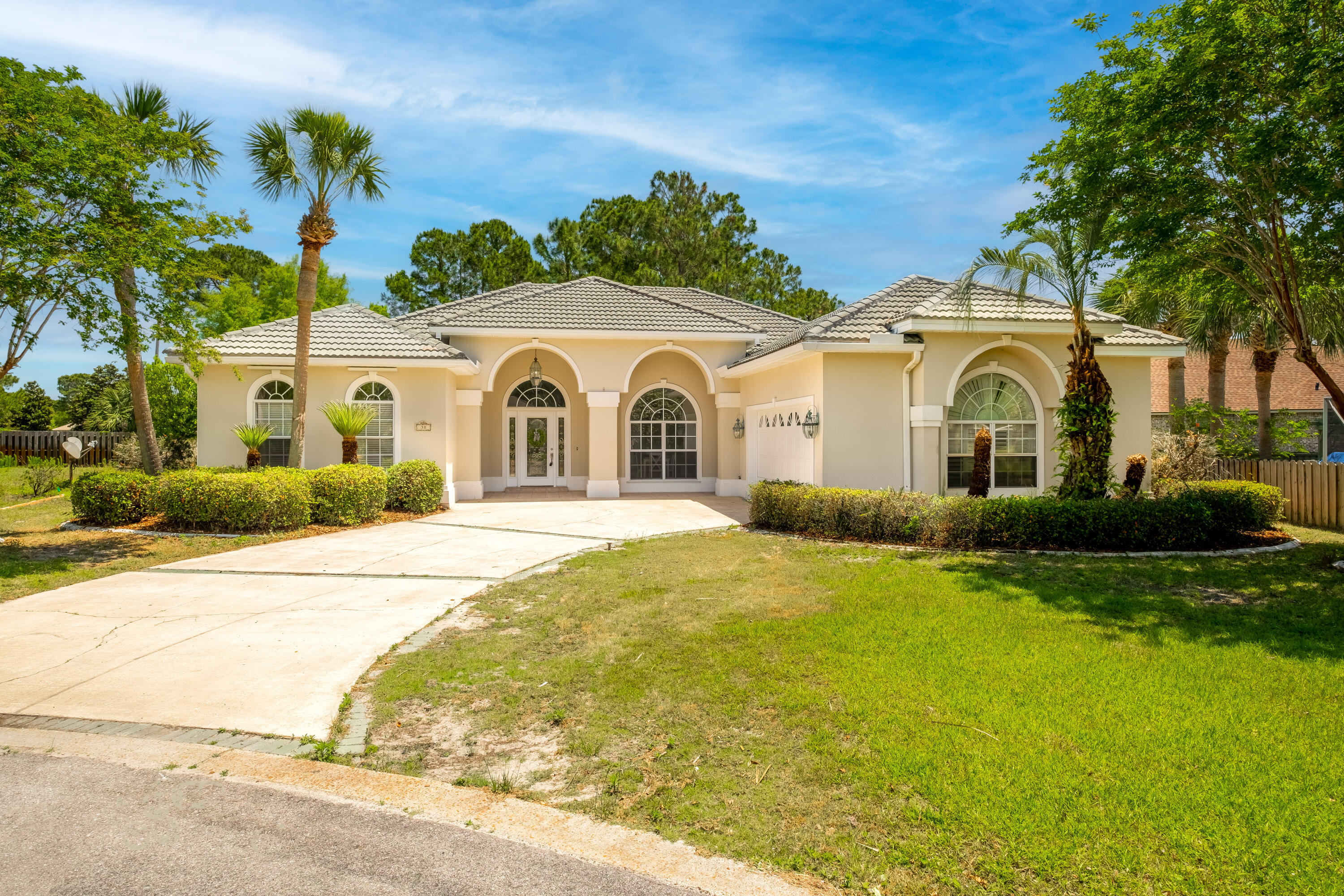38 Kristin Cove Destin, FL 32541 - Photo 2 of 57 a front view of a house with a garden