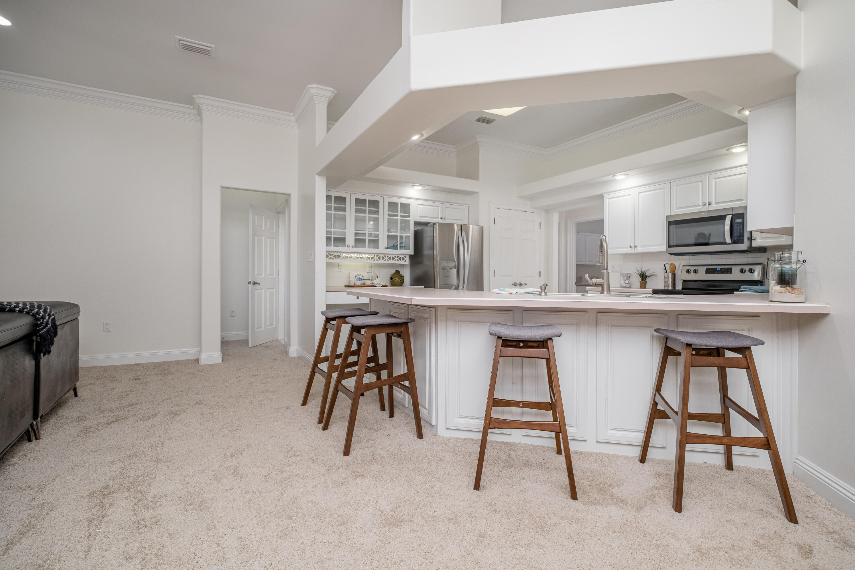 38 Kristin Cove Destin, FL 32541 - Photo 23 of 57 a kitchen with stainless steel appliances kitchen island a table chairs refrigerator and sink