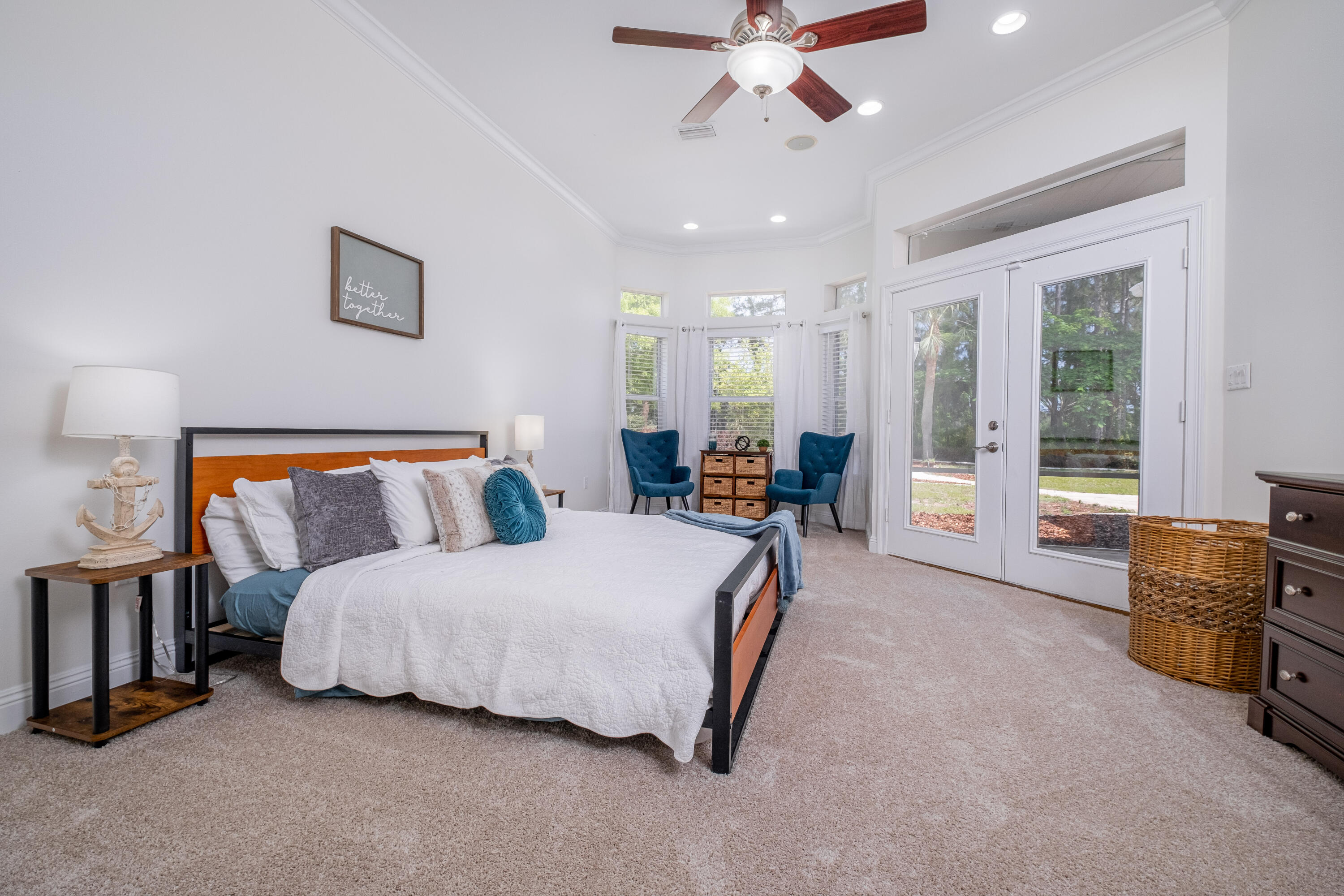 38 Kristin Cove Destin, FL 32541 - Photo 29 of 57 a spacious bedroom with a bed a chandelier and a dresser