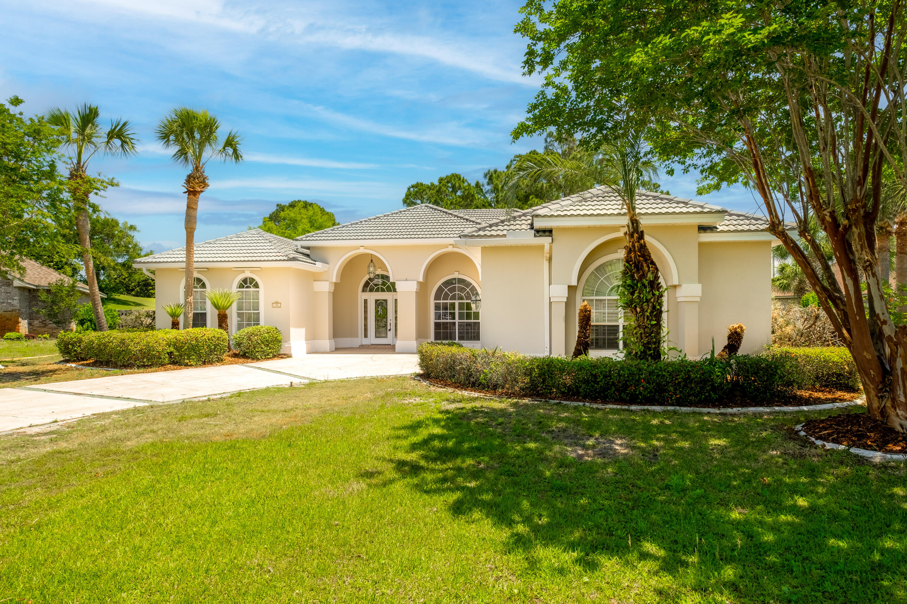 38 Kristin Cove Destin, FL 32541 - Photo 3 of 57 a view of a white house with garden and yard