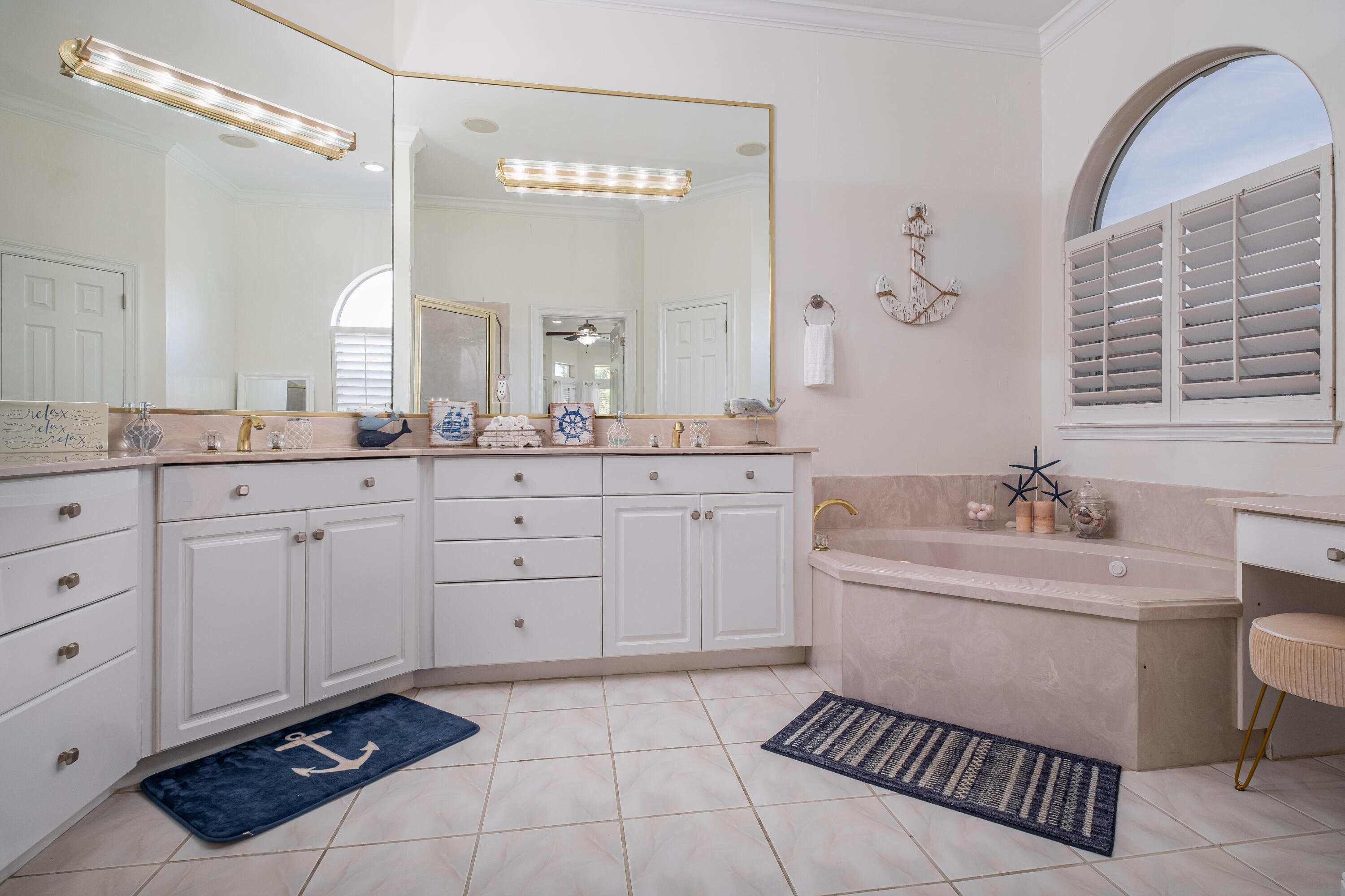 38 Kristin Cove Destin, FL 32541 - Photo 33 of 57 a spacious bathroom with a double vanity sink a mirror a bathtub and a window
