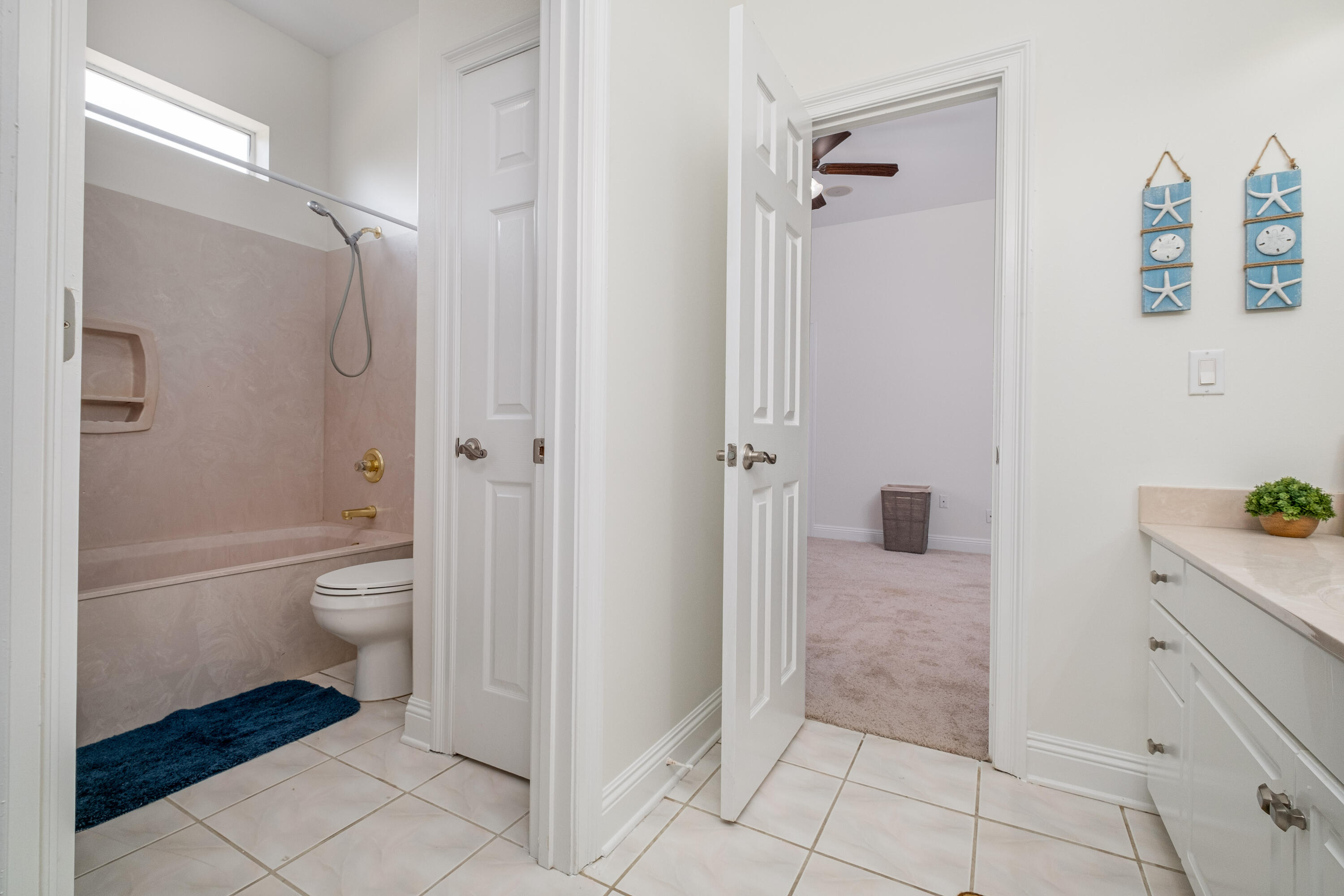 38 Kristin Cove Destin, FL 32541 - Photo 40 of 57 a bathroom with a granite countertop shower a toilet and a shower