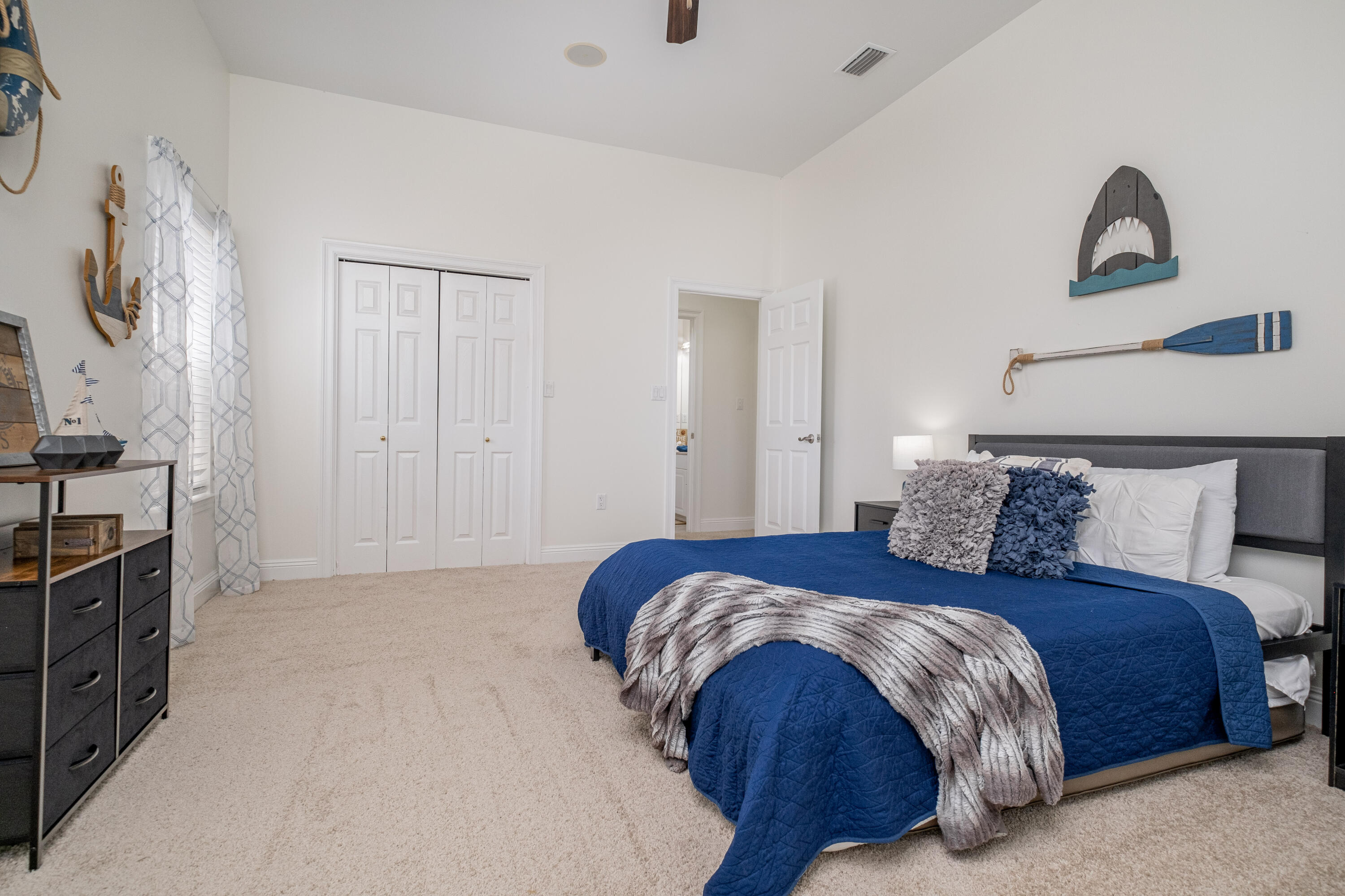 38 Kristin Cove Destin, FL 32541 - Photo 42 of 57 a bedroom with a bed and a flat tv screen on the dresser