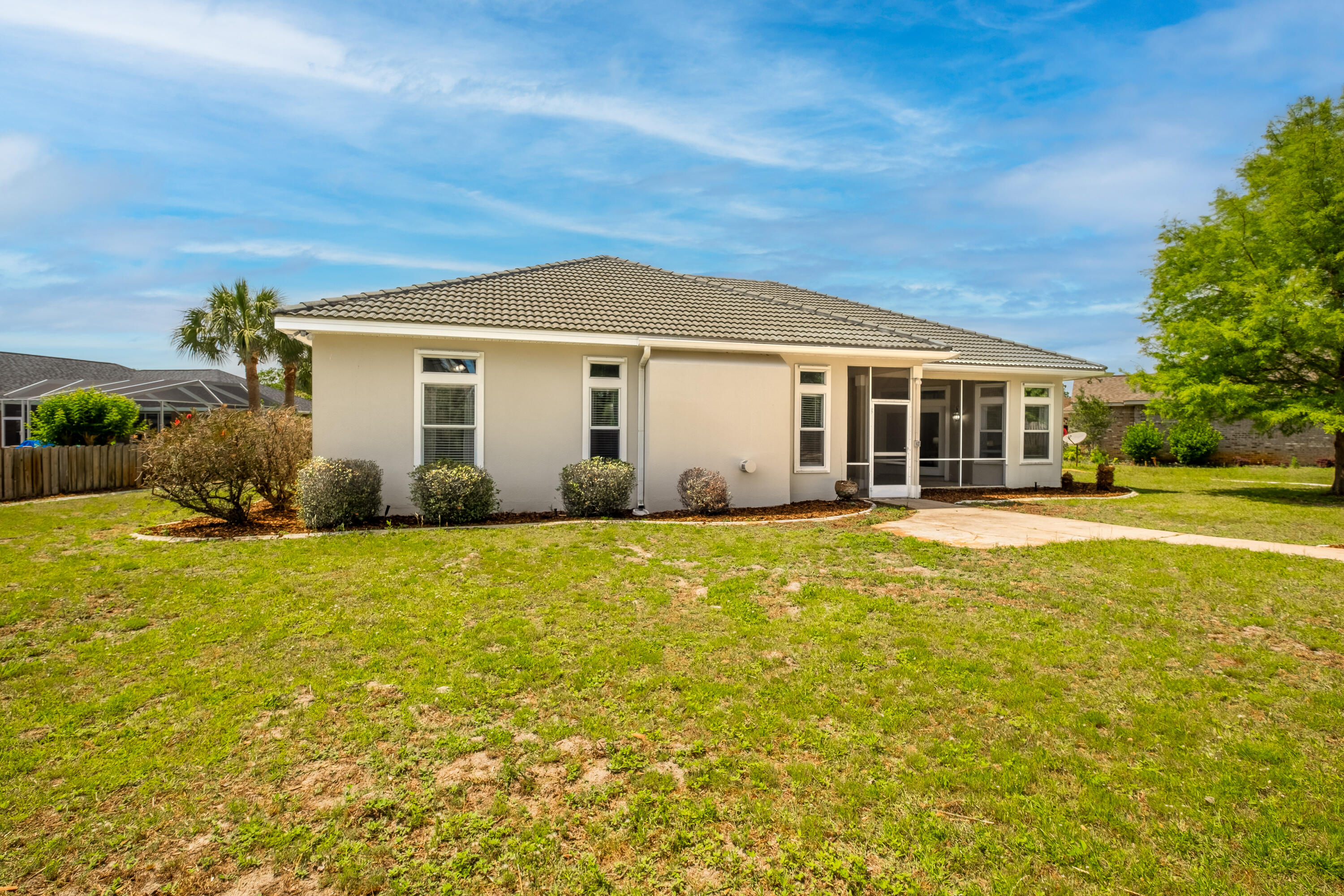38 Kristin Cove Destin, FL 32541 - Photo 49 of 57 a front view of a house with a garden