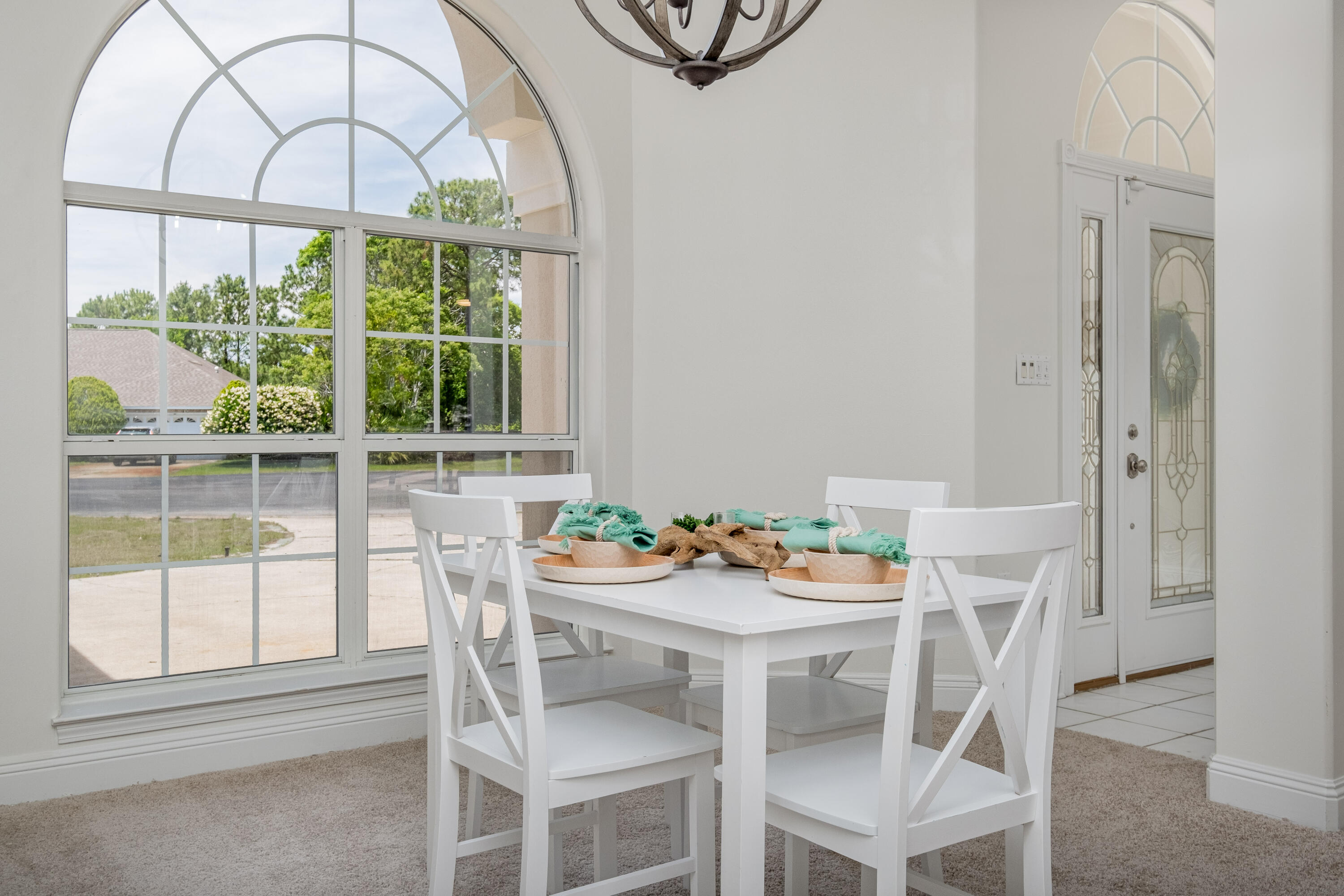 38 Kristin Cove Destin, FL 32541 - Photo 9 of 57 a dining room with furniture a rug and a large window