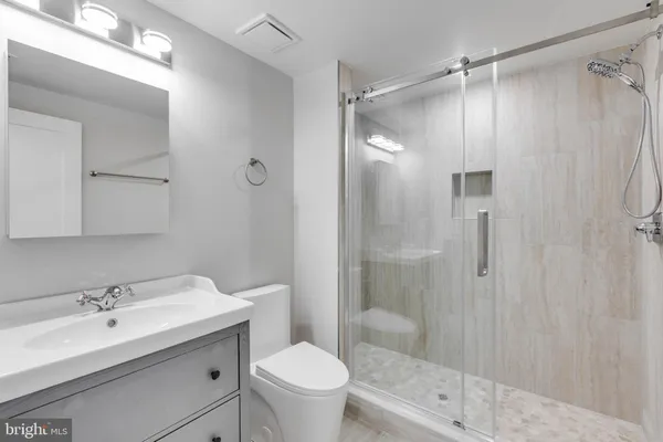 a bathroom with a sink toilet and shower