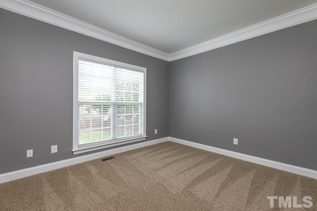 108 Quarryrock Road Holly Springs, NC 27540 - Photo 18 of 30 a view of an empty room with a window