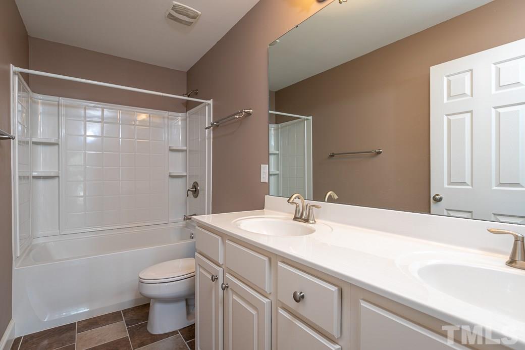 108 Quarryrock Road Holly Springs, NC 27540 - Photo 22 of 30 a bathroom with a sink a toilet and shower